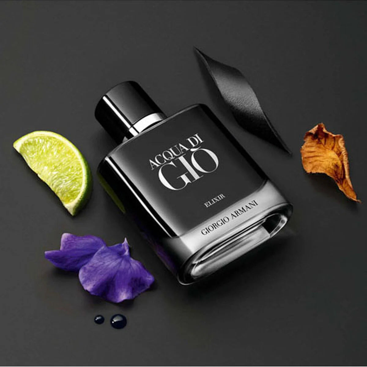 Black Giorgio Armani Acqua di Gio Elixir perfume bottle with decorative elements on a dark background