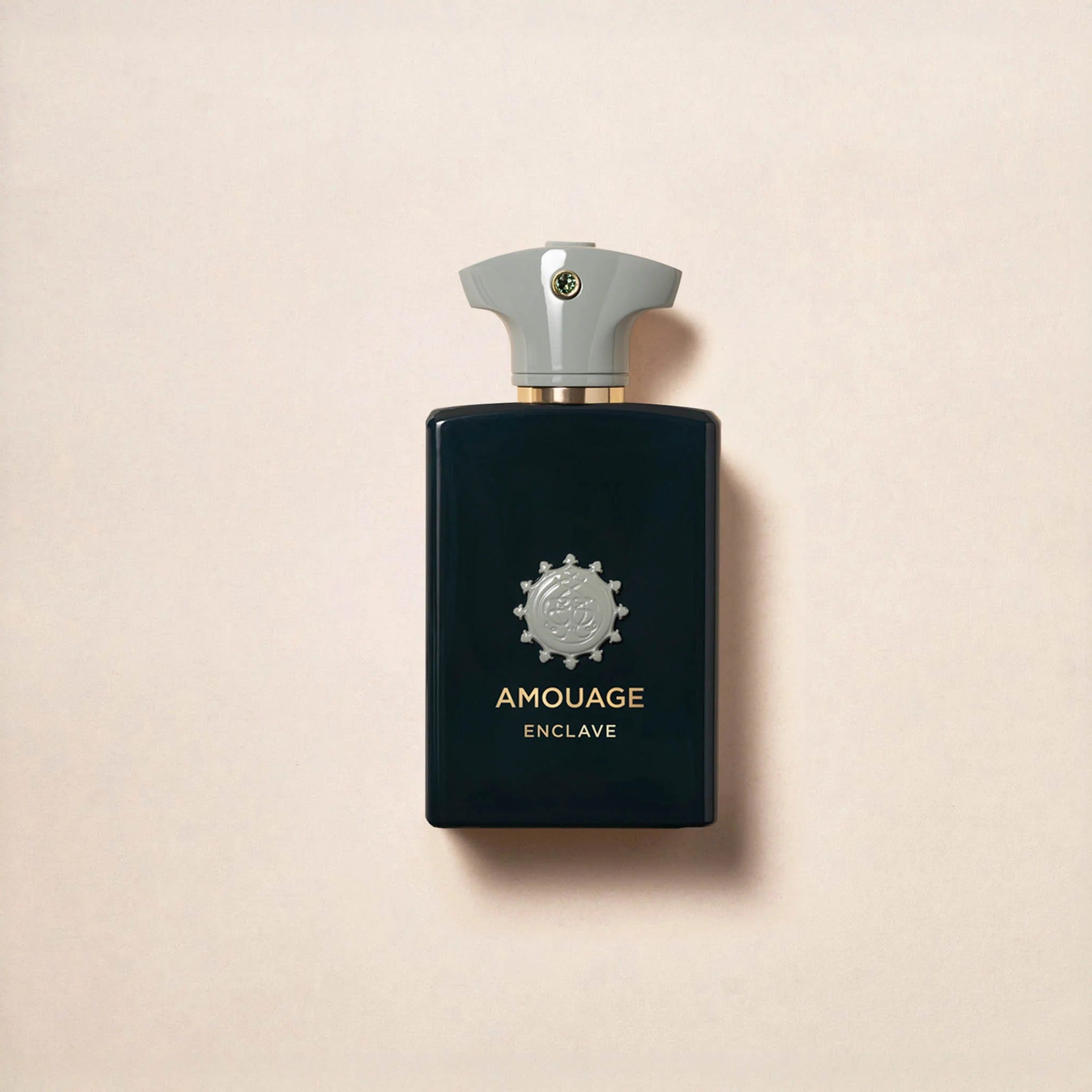 Amouage Enclave perfume bottle on a beige background